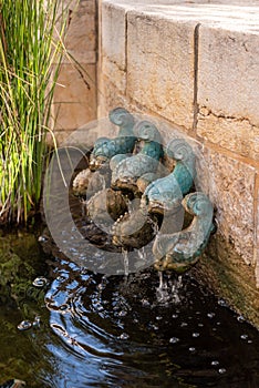 Bronze fish fountain in the courtyard of Tabgha or The Church of the Multiplication of the Loaves and Fishes