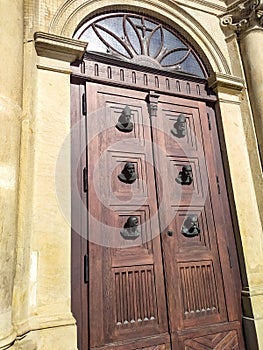 Bronze heads on the door of the Mariacki, the Church of St Mary in Krakow, Poland