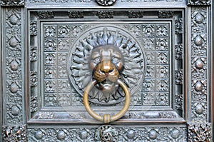 Bronze knocker in the shape of a lion head from the gate of the Cologne Cathedral, Germany