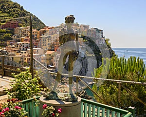 Bronze Lady of the Grapes statue in Manarola, the second smallest of the famous Cinque Terre towns, Italy