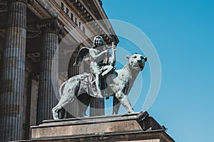 Bronze lion and angel statue in front of the Berlin Concert Hall or Konzerthaus on Gendarmenmarkt  in Berlin