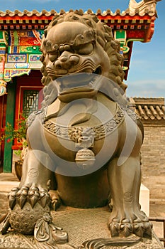 Bronze lion, son of a dragon guards the entrance to the Palace of Garden of Peace and Harmony. Beijing, China