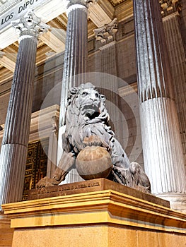 Bronze lion statue at Congreso de los deputados congress of deputies Madrid Spain at night