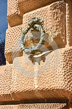 Bronze Lions Head on stone wall at the Palace of Alhambra