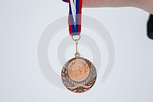 Bronze medal in white background for winners in winter games