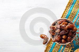 Bronze plate with dates on old white wooden table.  Flat lay