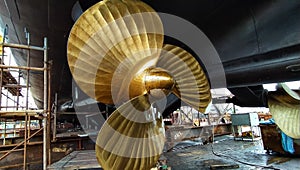 bronze propeller of warship while docking at shipyard