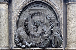 Bronze Relief of Luther playing guitar and singing with his family - wife and children. Lutherdenkmal statue in Eisleben, his