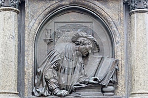 Bronze Relief of Luther translating the Bible. Lutherdenkmal statue in Eisleben, his birth and death place,  Germany. Monument by