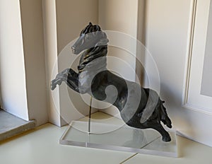 Bronze sculpture of black horse rearing, artist unknown.