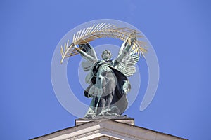 Bronze sculpture genius with gold palm branch and wings on the roof of the opera and ballet theatre in Lviv, Ukraine photo