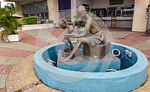 Bronze sculpture of a woman dressed in Yoruba attire with hair braid in Premier Hotel Ibadan Nigeria West Africa.