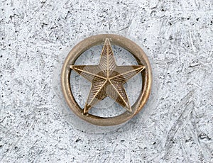 Bronze star on cement background