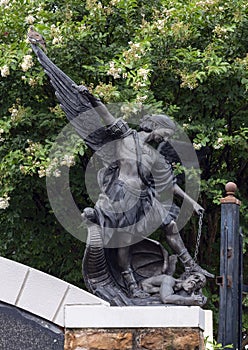 Bronze statue of the Archangel Saint Michael defeating Lucifer at the Blessed Sacrament Catholic Church in Dallas, Texas.