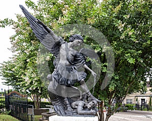 Bronze statue of the Archangel Saint Michael defeating Lucifer at the Blessed Sacrament Catholic Church in Dallas, Texas.