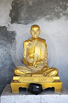 Bronze statue of Bhuddist monk with rough background