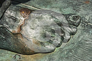 Bronze statue close up of a right male foot