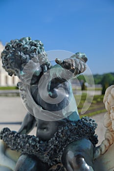Bronze statue of Cupidon in Versailles, France photo