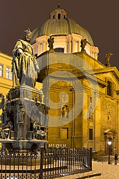 Bronze statue of the eleventh Czech King and Roman Emperor Charles IV. in night snowy Prague near Charles Bridg