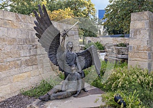 Bronze statue of fallen soldier and the Archangel Michael at the entrance to the Veteran`s Memorial Park in Irving, Texas.