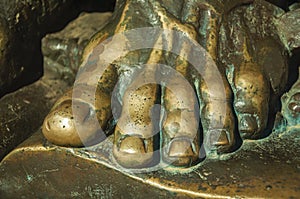 Bronze statue of foot over an open book at Caceres