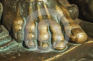 Bronze statue of foot over an open book at Caceres