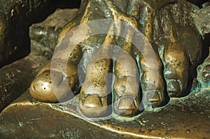 Bronze statue of foot over an open book at Caceres photo