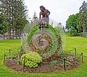 Bronze statue of Indian hunter and dog, Cooperstown in Spring