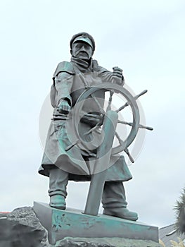 Bronze statue of lifeboatman at steering wheel