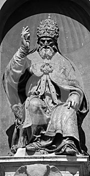 Bronze statue of Pope Gregory XIII, sitting and blessing.