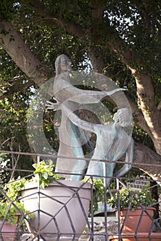 Bronze statue standing in the courtyard of the Church of the Primacy of St. Peter, located on the shores of the Sea of Galilee in