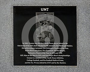 Bronze statue titled `Mean Joe Green` by sculptor Brian Hanolon at the entrance to Apogee Stadium of the University of North Texas