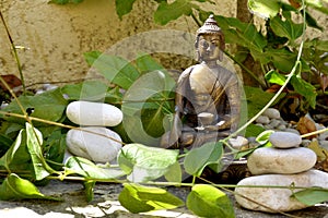 Bronze statue of Touching earth Buddha with balanced stones photo