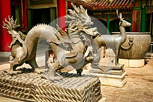 Bronze statues of the dragon and deer in the Forbidden City. Beijing