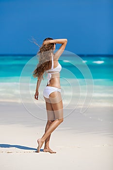 Bronze Tan Woman Sunbathing At Tropical Beach