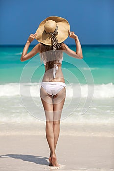 Bronze Tan Woman Sunbathing At Tropical Beach