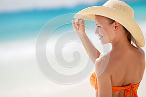 Bronze Tan Woman Sunbathing At Tropical Beach