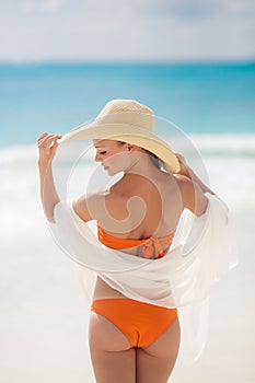 Bronze Tan Woman Sunbathing At Tropical Beach