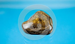 A bronzite as tumbled gemstone and healing stone