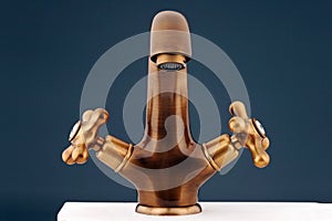 Bronzy metal tap of retro design. Faucet