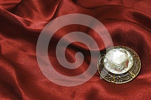 Brooch with zircon on red silk photo