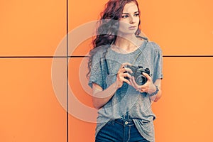 Broody Hipster Girl Photographer Looking Away With Vintage Film Camera In Her Hands photo