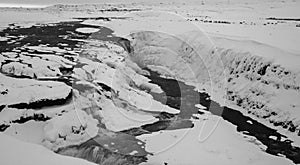 brook run in the icelandic wilderness, landscape covered with snow