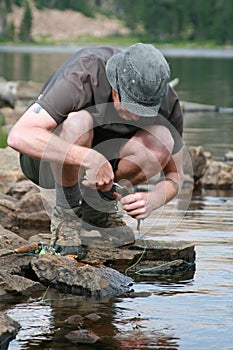 Brook trout dehooked by fisher