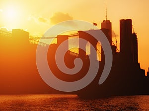 The Brooklyn Bridge and the downtown Manhattan skyline at sunse