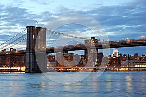 Brooklyn Bridge with downtown skyline at dusk