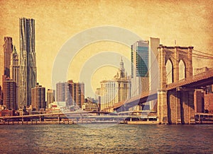 Brooklyn Bridge and Lower Manhattan  in New York City, United States. Photo in retro style. Added paper texture