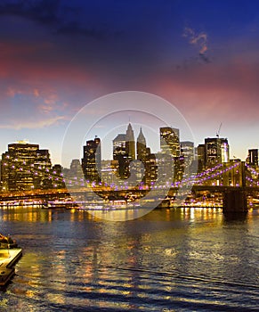 Brooklyn Bridge and Manhattan at sunset on East River, New York