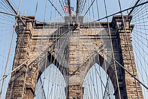 Brooklyn Bridge at New York City with American flag