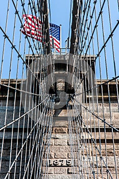 Brooklyn Bridge at New York City with American flag